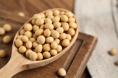 Photo of Natural soy beans on wooden table, closeup