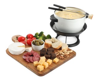 Fondue with tasty melted cheese, forks and different snacks isolated on white