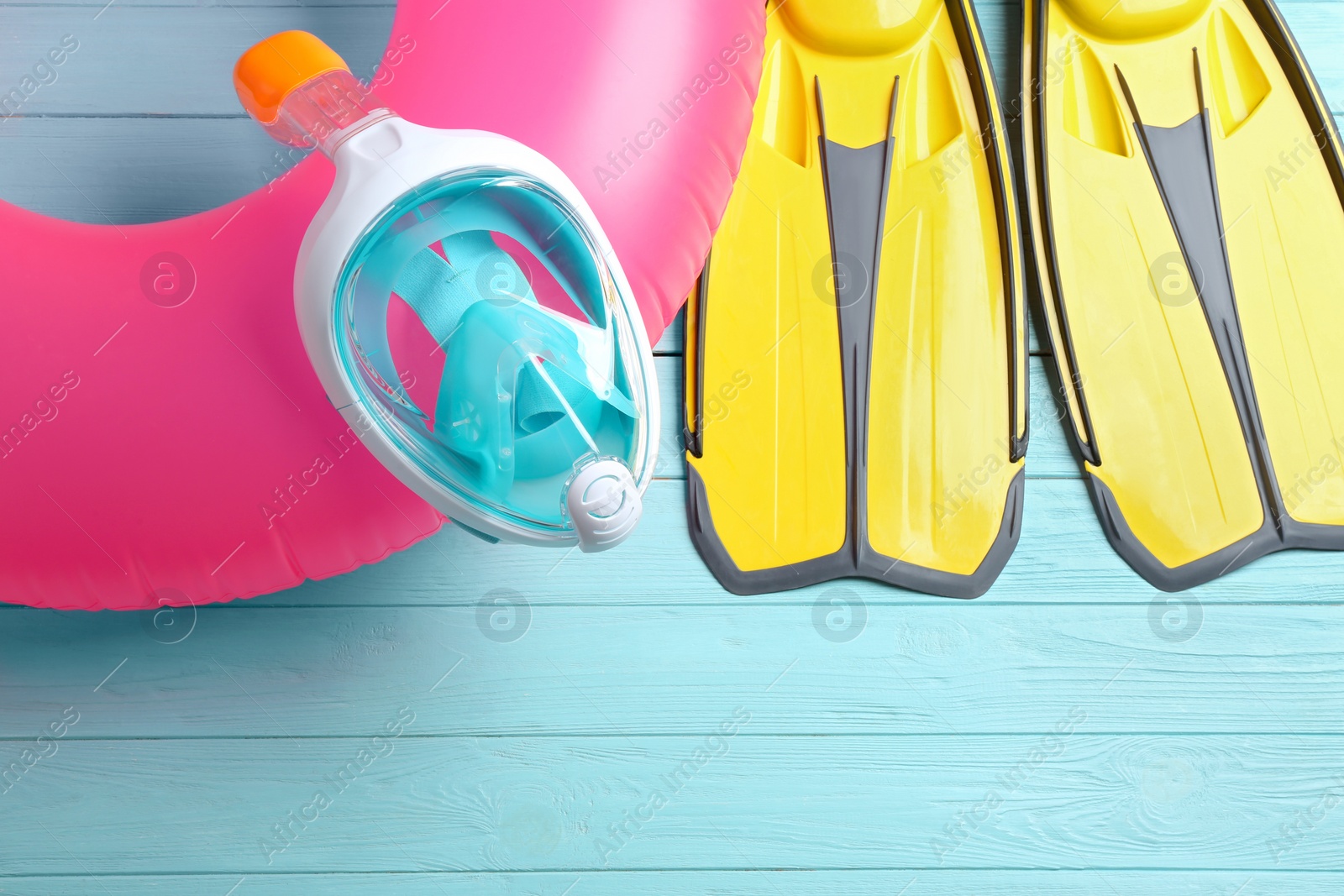 Photo of Flat lay composition with beach accessories on light blue wooden background, space for text