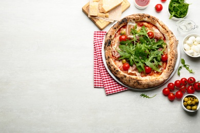 Photo of Tasty pizza with meat and arugula, flat lay. Space for text