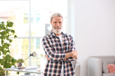 Portrait of handsome mature man in shirt, indoors