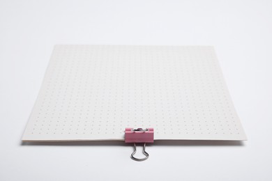 Photo of Sheets of paper with clip on white background