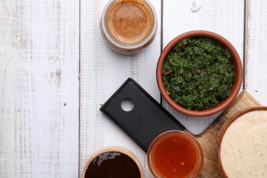 Photo of Different fresh marinades on white wooden table, flat lay. Space for text