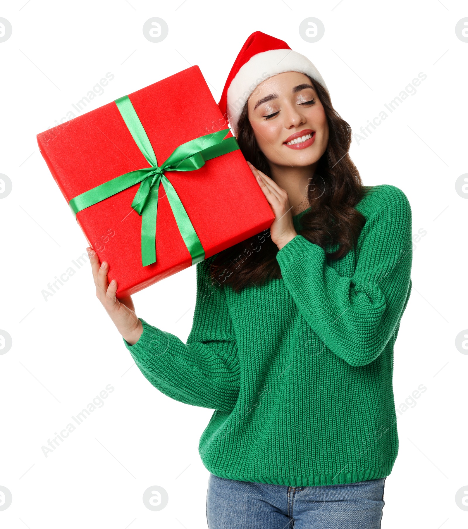 Photo of Beautiful young woman in Santa hat with Christmas celebration gift isolated on white