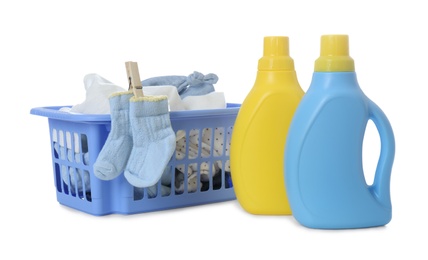 Photo of Detergents and children's clothes on white background