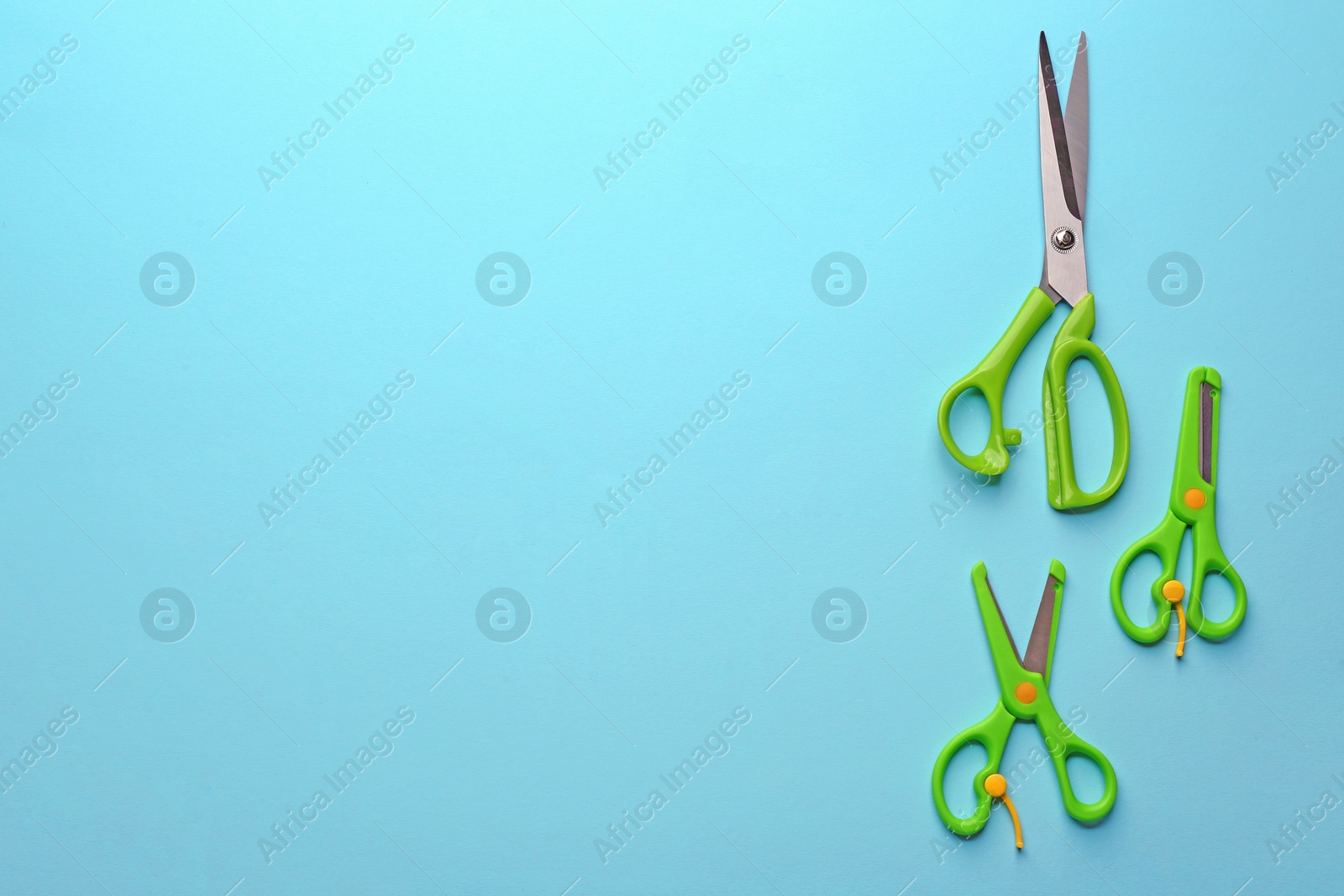 Photo of Set of different scissors on color background, flat lay. Space for text