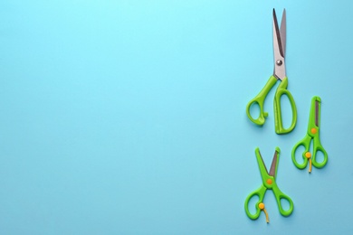 Set of different scissors on color background, flat lay. Space for text