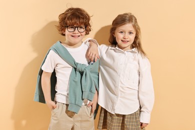 Fashion concept. Stylish children on pale orange background