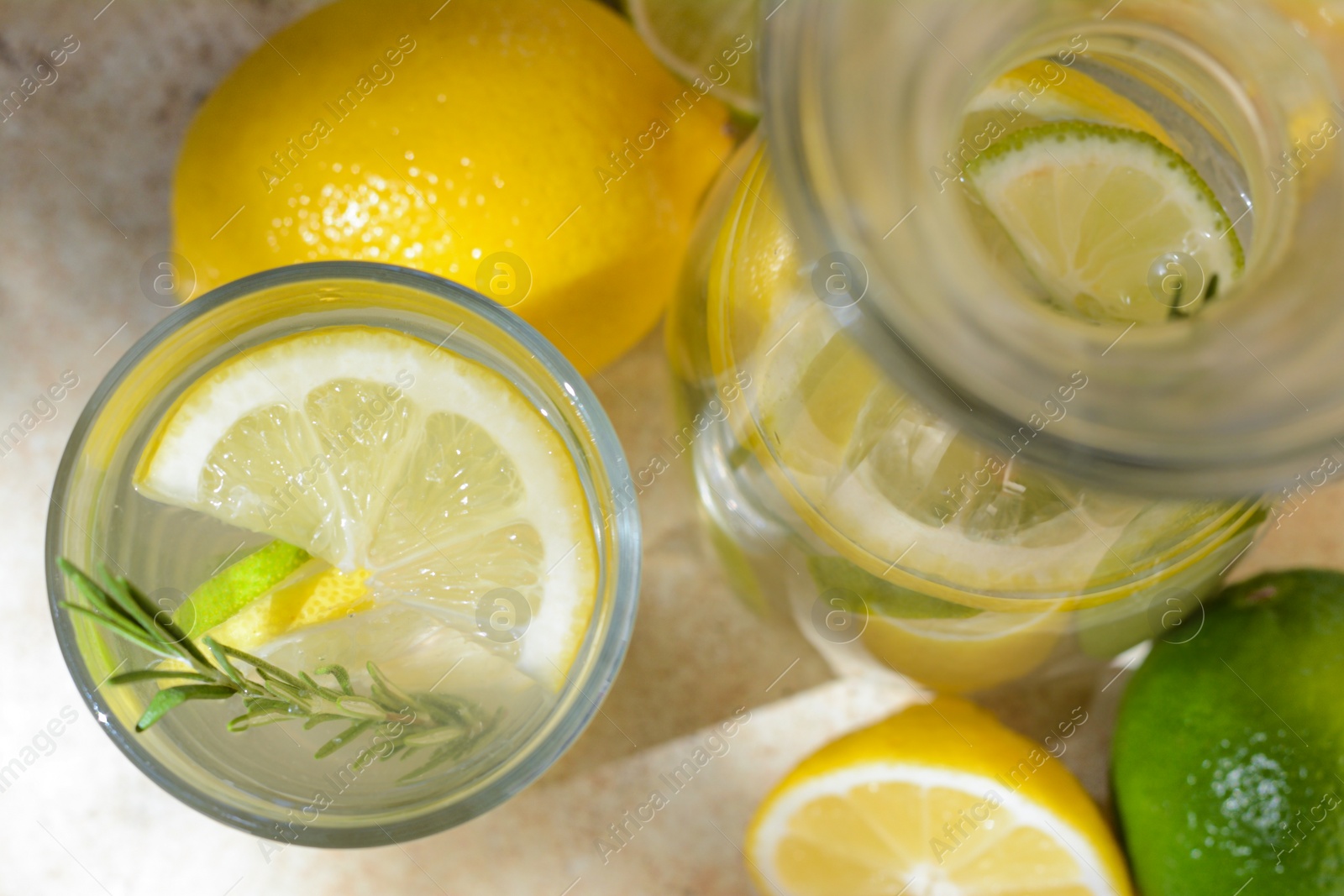 Photo of Summer refreshing lemonade drink with ingredients on light table, top view