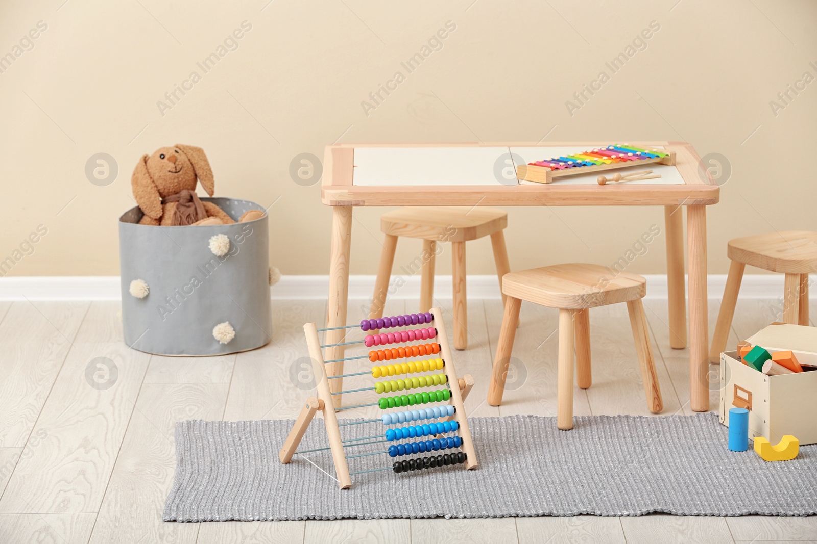 Photo of Stylish child's room interior with toys and new furniture