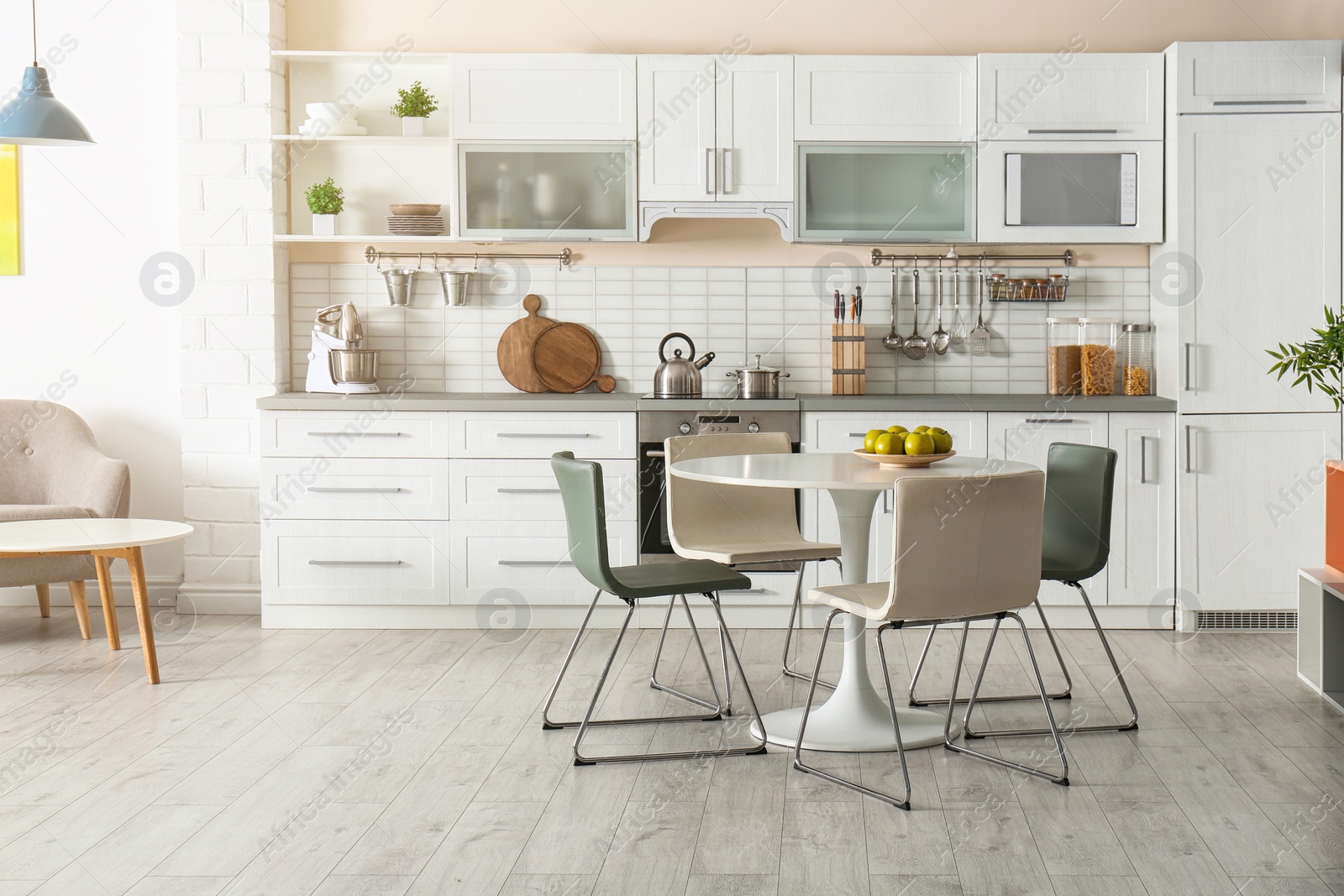 Photo of Stylish kitchen interior with dining table and chairs