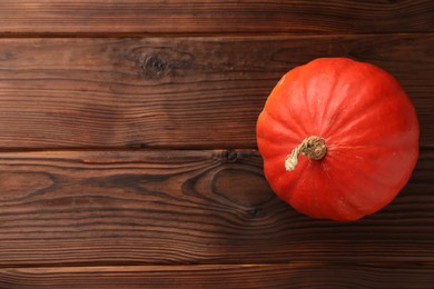 Photo of Fresh orange pumpkin on wooden table, top view. Space for text