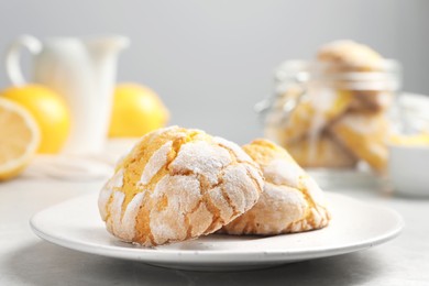 Photo of Plate with delicious lemon cookies on table, closeup