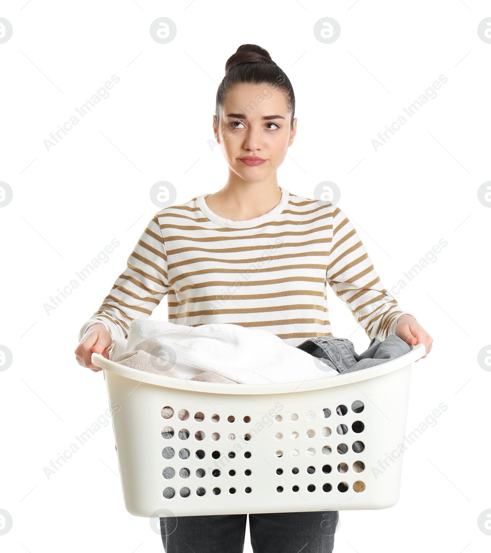 Photo of Displeased young woman holding basket with laundry on white background