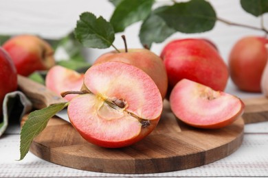 Tasty apples with red pulp on white wooden table, closeup