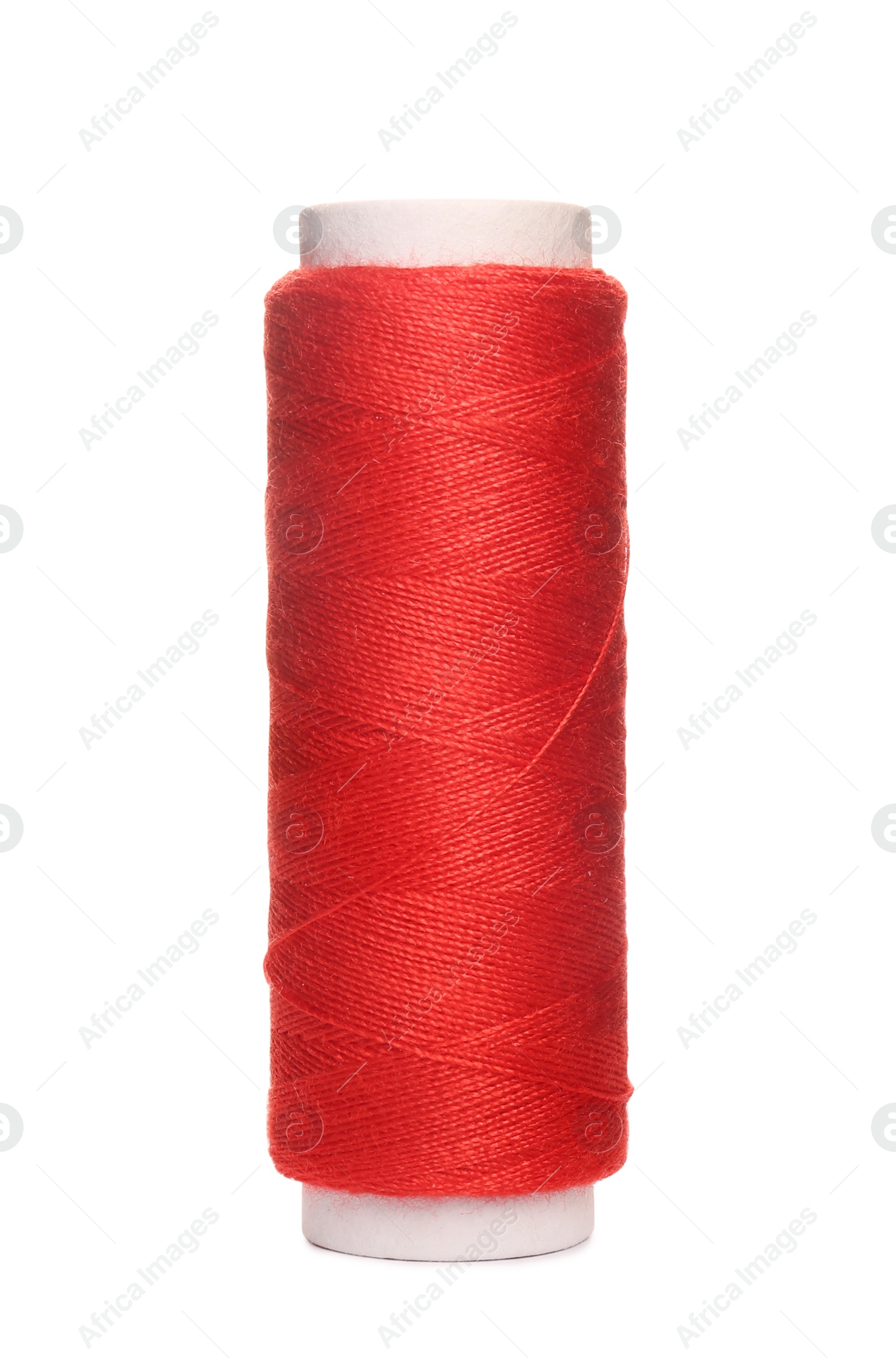 Photo of Spool of red sewing thread isolated on white