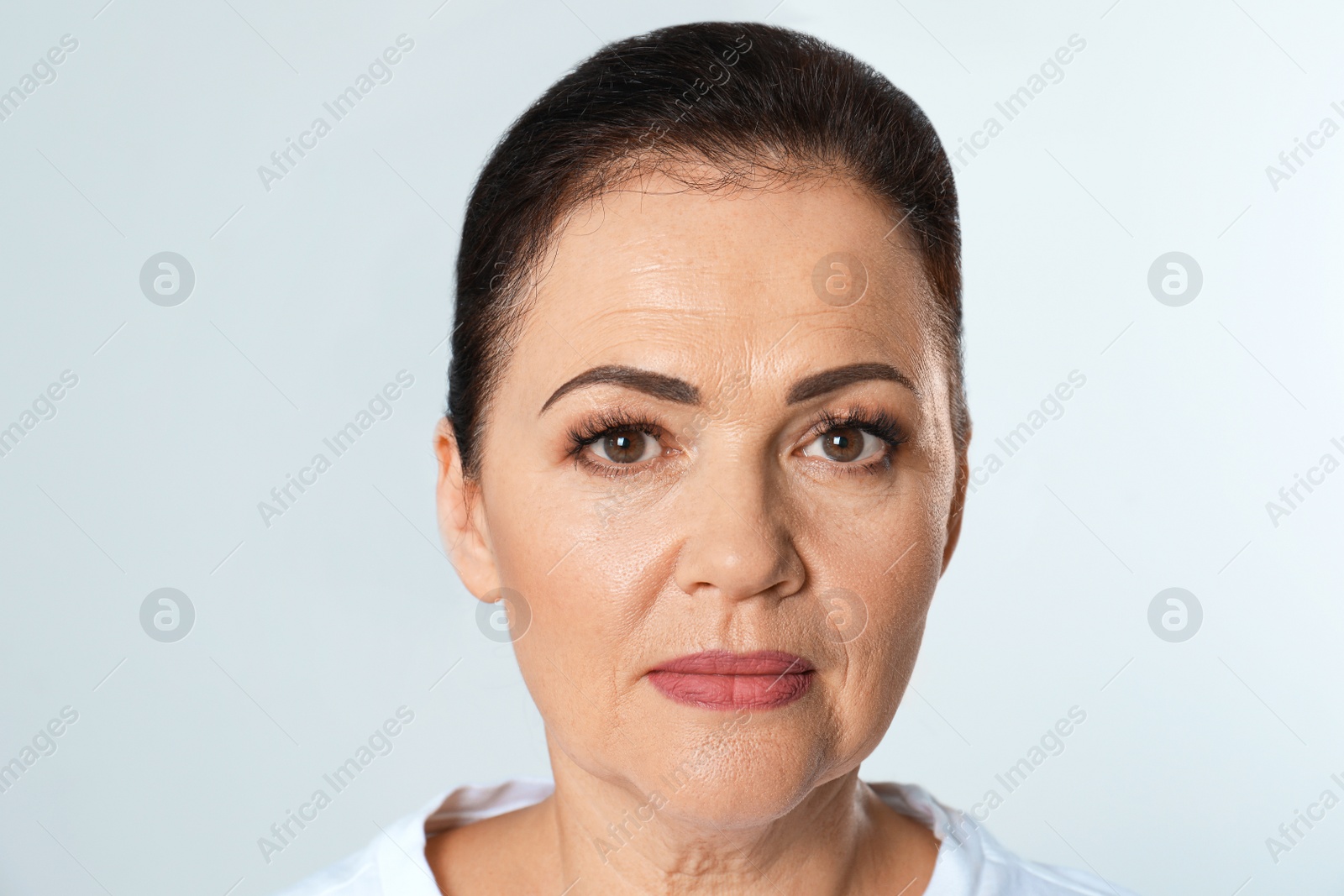 Photo of Portrait of beautiful older woman on white background