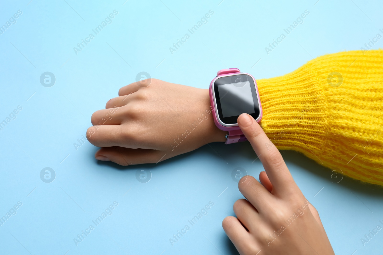 Photo of Girl with stylish smart watch on light blue background, closeup