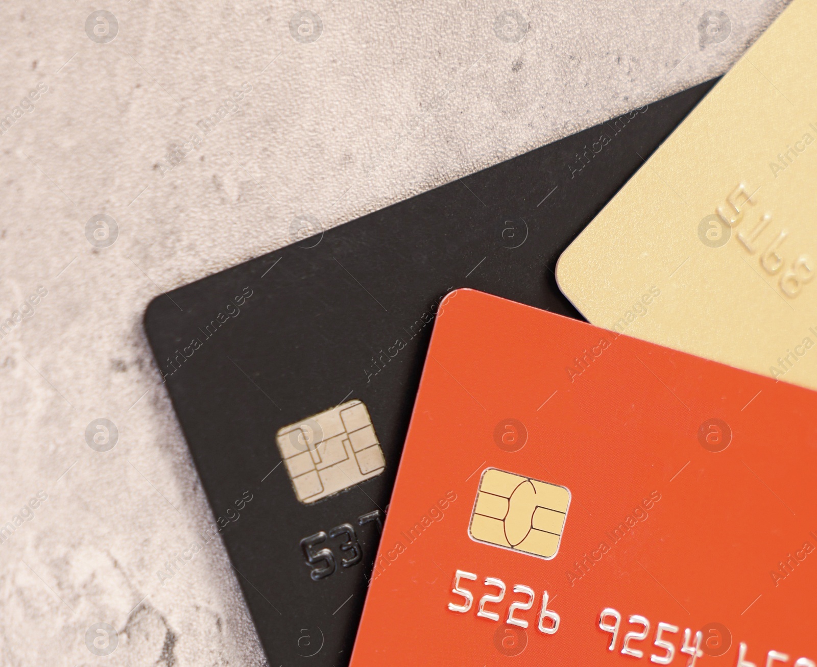 Photo of Many different bank cards on grey table, top view