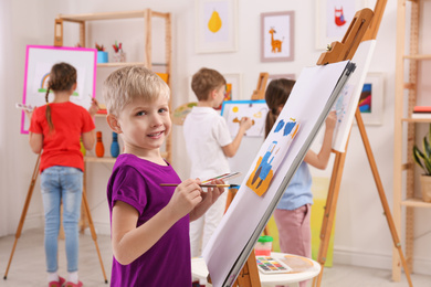 Cute little children painting during lesson in room