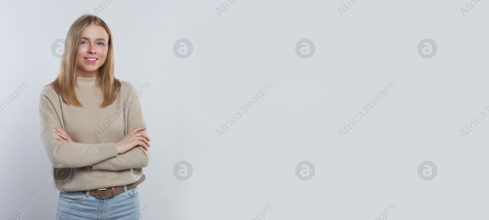 Image of Portrait of beautiful young woman on light background. Banner design with space for text