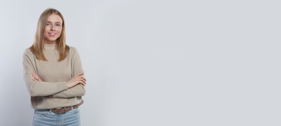 Image of Portrait of beautiful young woman on light background. Banner design with space for text