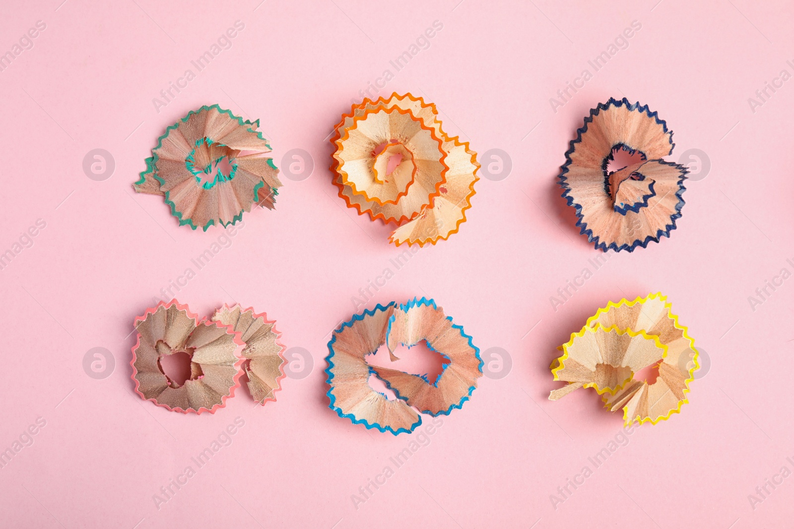 Photo of Pencil shavings on pink background, flat lay