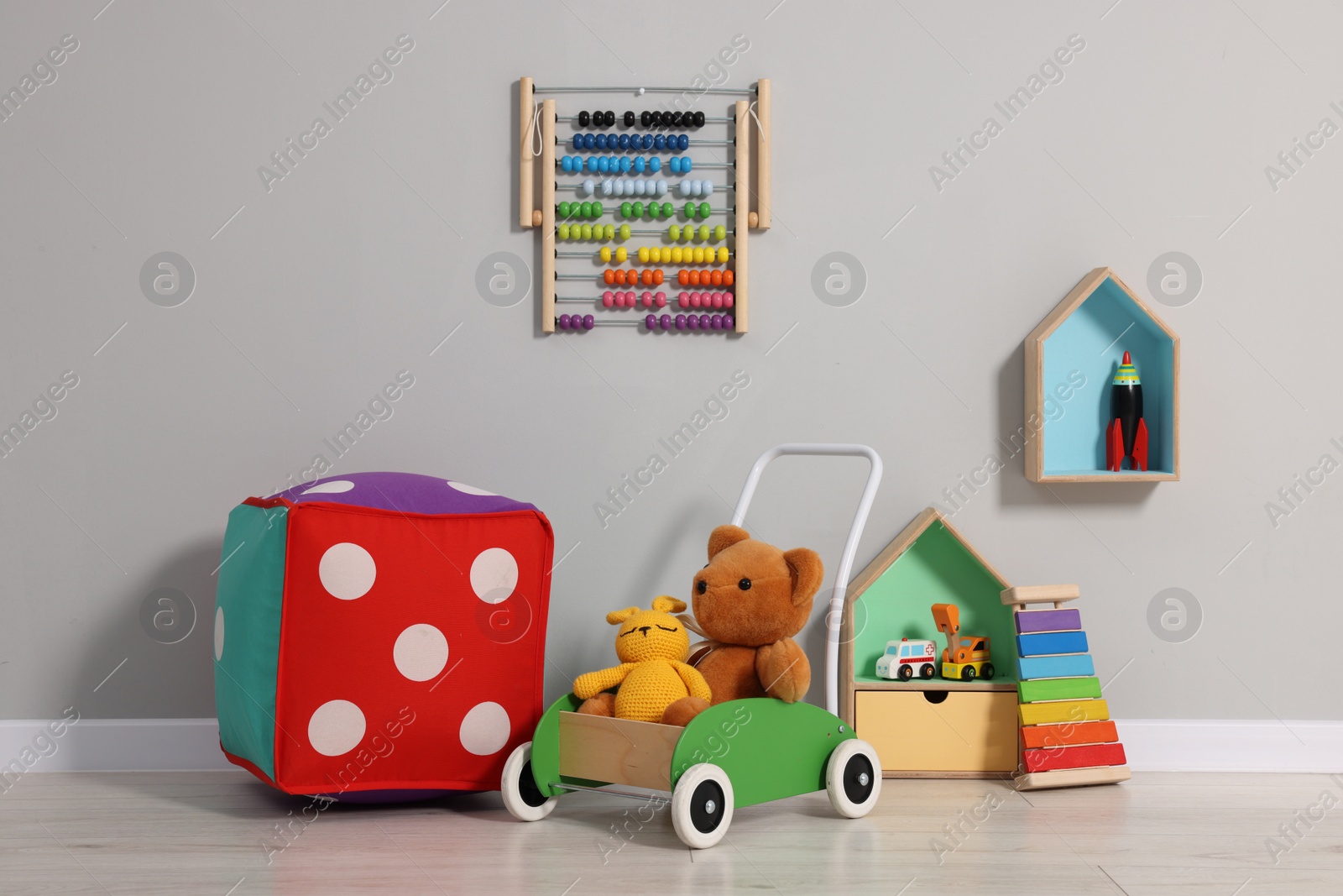 Photo of Beautiful children's room with grey wall and toys. Interior design