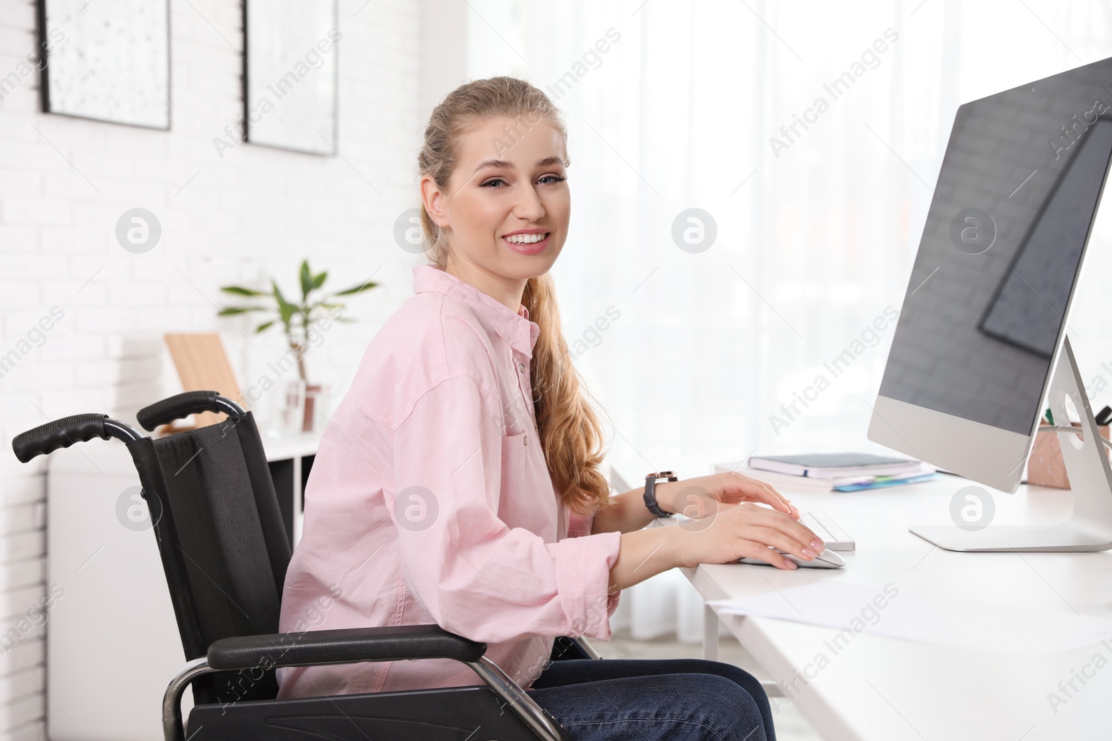 Photo of Portrait of woman in wheelchair at workplace