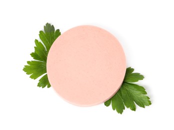 Slice of delicious boiled sausage with parsley on white background, top view