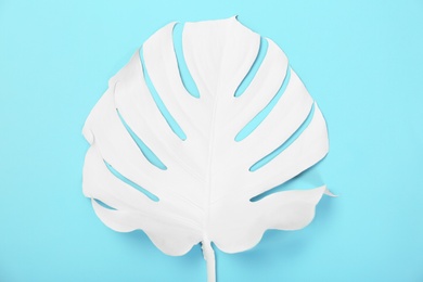 Photo of Painted tropical Monstera leaf on color background, top view