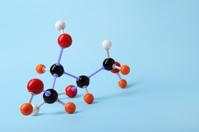 Photo of Molecule of sugar on light blue background, space for text. Chemical model
