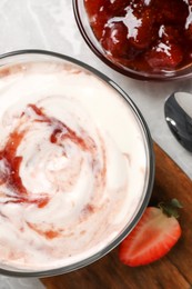 Tasty yoghurt with jam and strawberry on grey table, flat lay