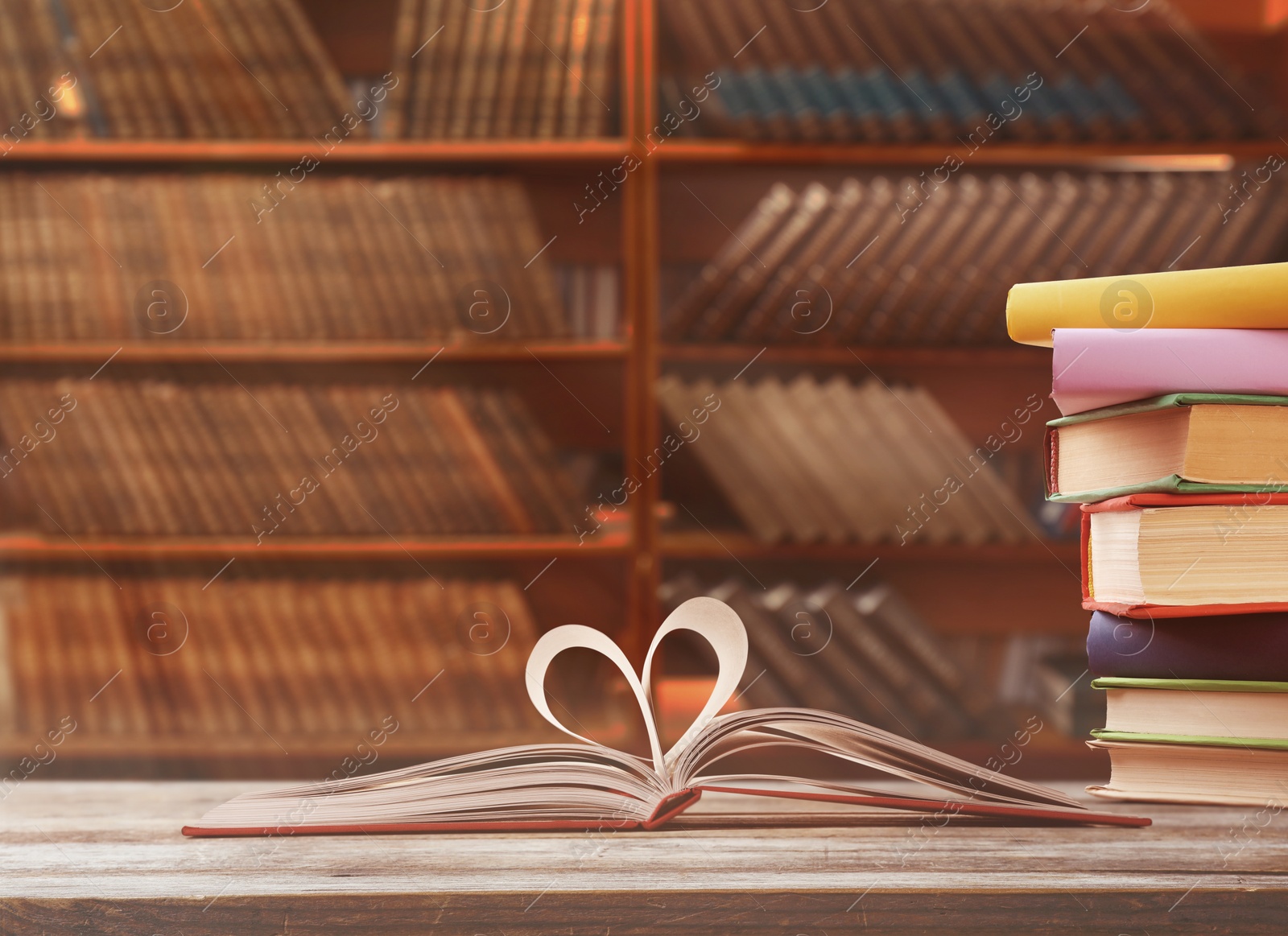 Image of Open book with pages folded in heart in library