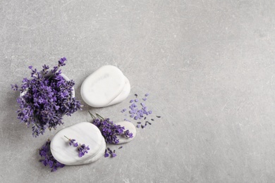 Photo of Stones, sea salt and lavender flowers on grey table, flat lay. Space for text