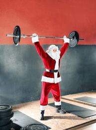 Photo of Young Santa Claus training in modern gym