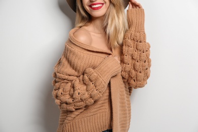 Photo of Beautiful young woman in warm sweater on white background