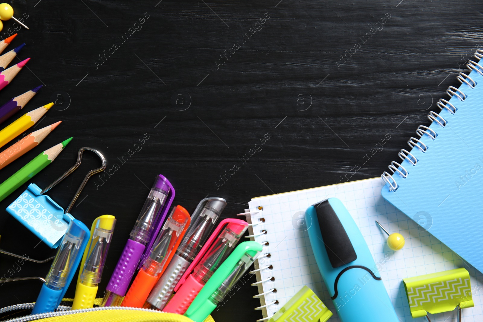 Photo of Different school stationery with space for design on wooden background, flat lay