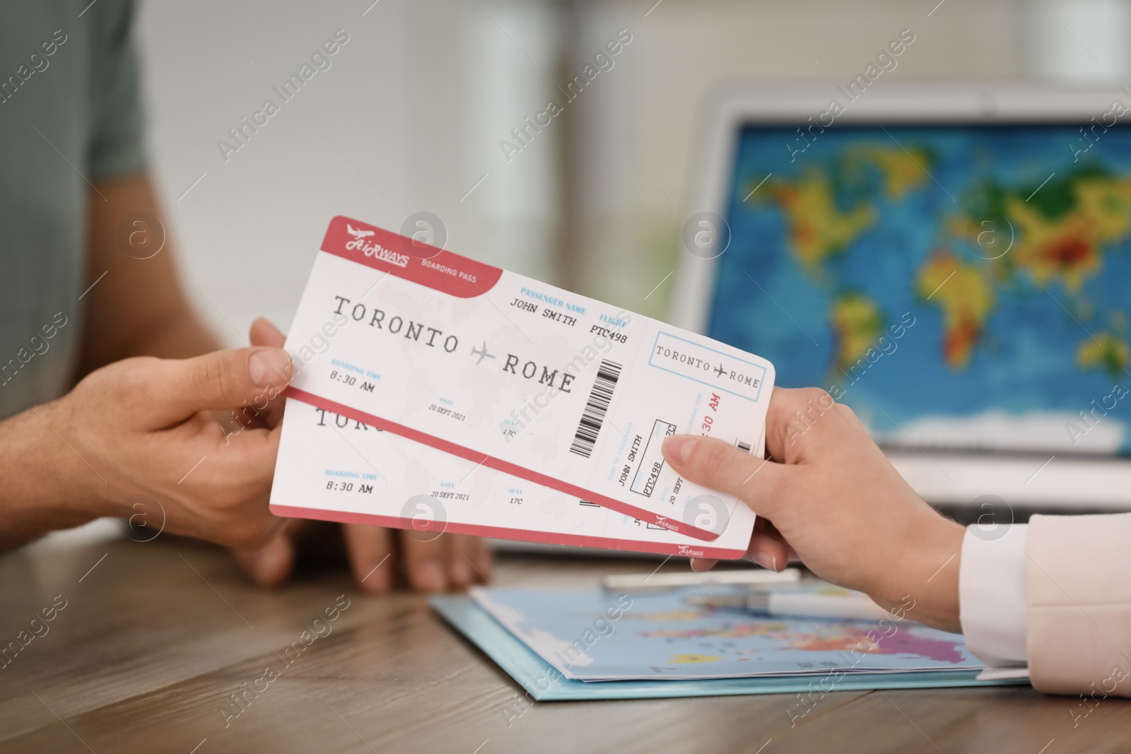 Photo of Travel agent giving tickets to client in office, closeup