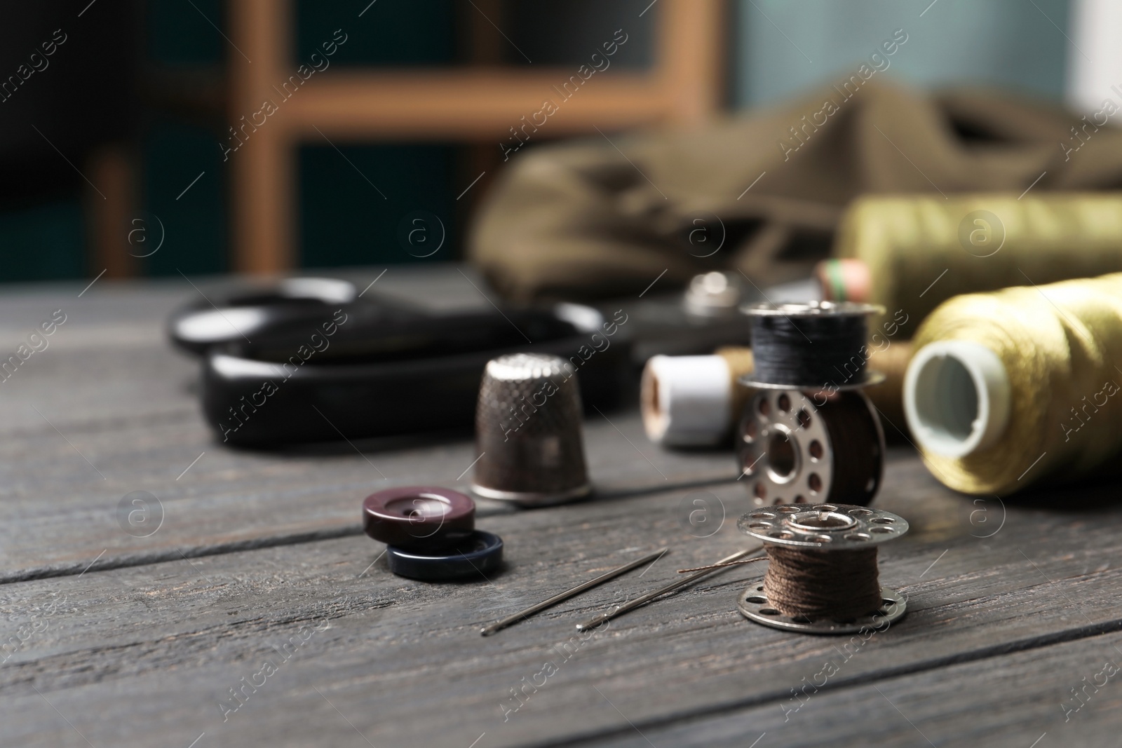 Photo of Bobbins with threads on table. Tailoring accessories