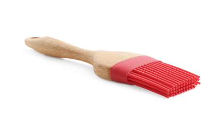 Red silicone brush with wooden handle isolated on white. Cooking utensil
