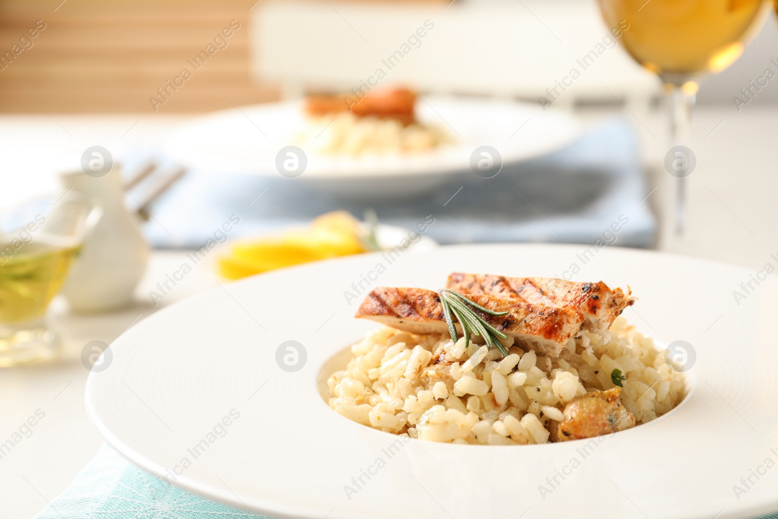 Photo of Delicious chicken risotto served on table, closeup