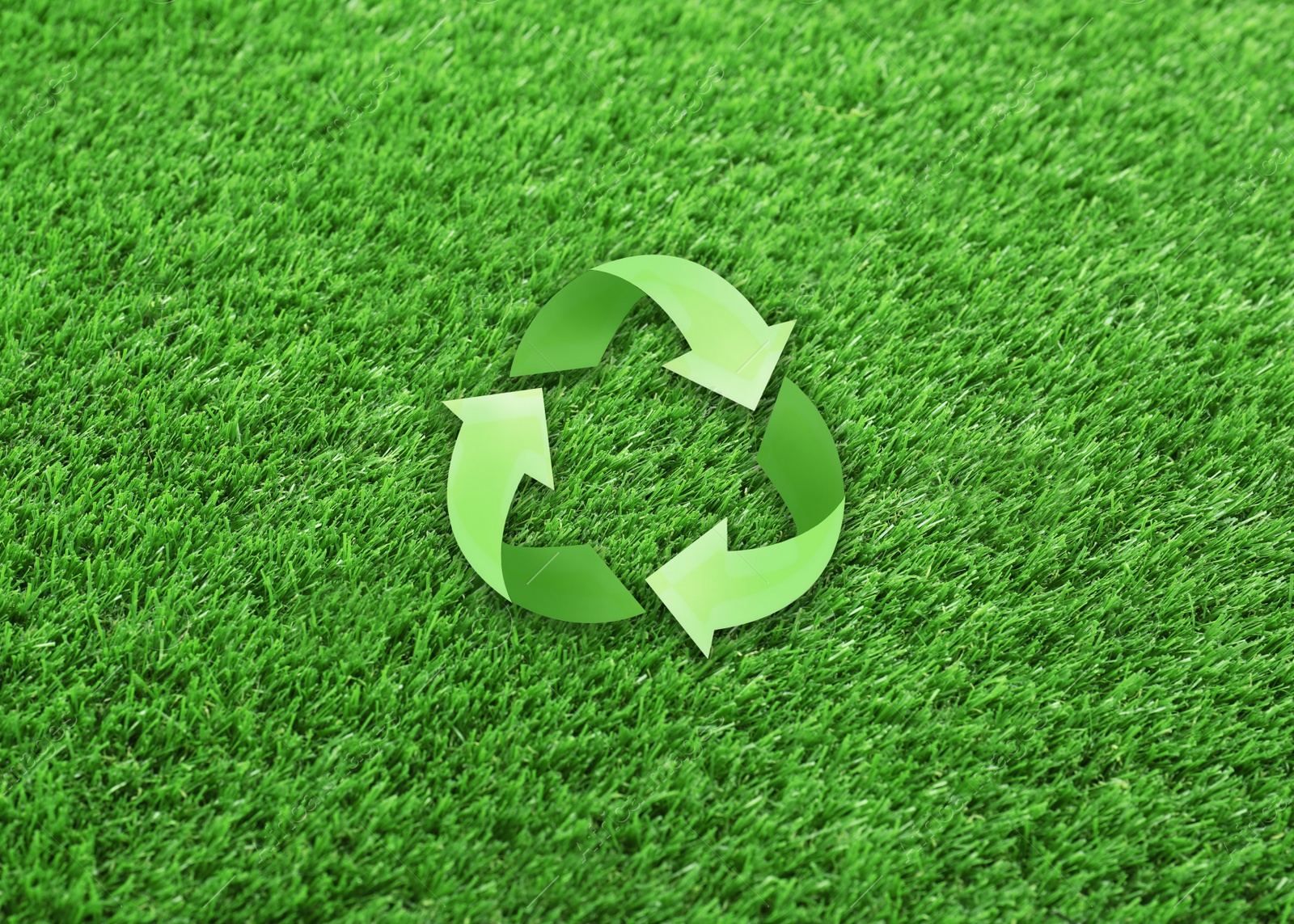 Image of Illustration of recycling symbol and artificial grass carpet