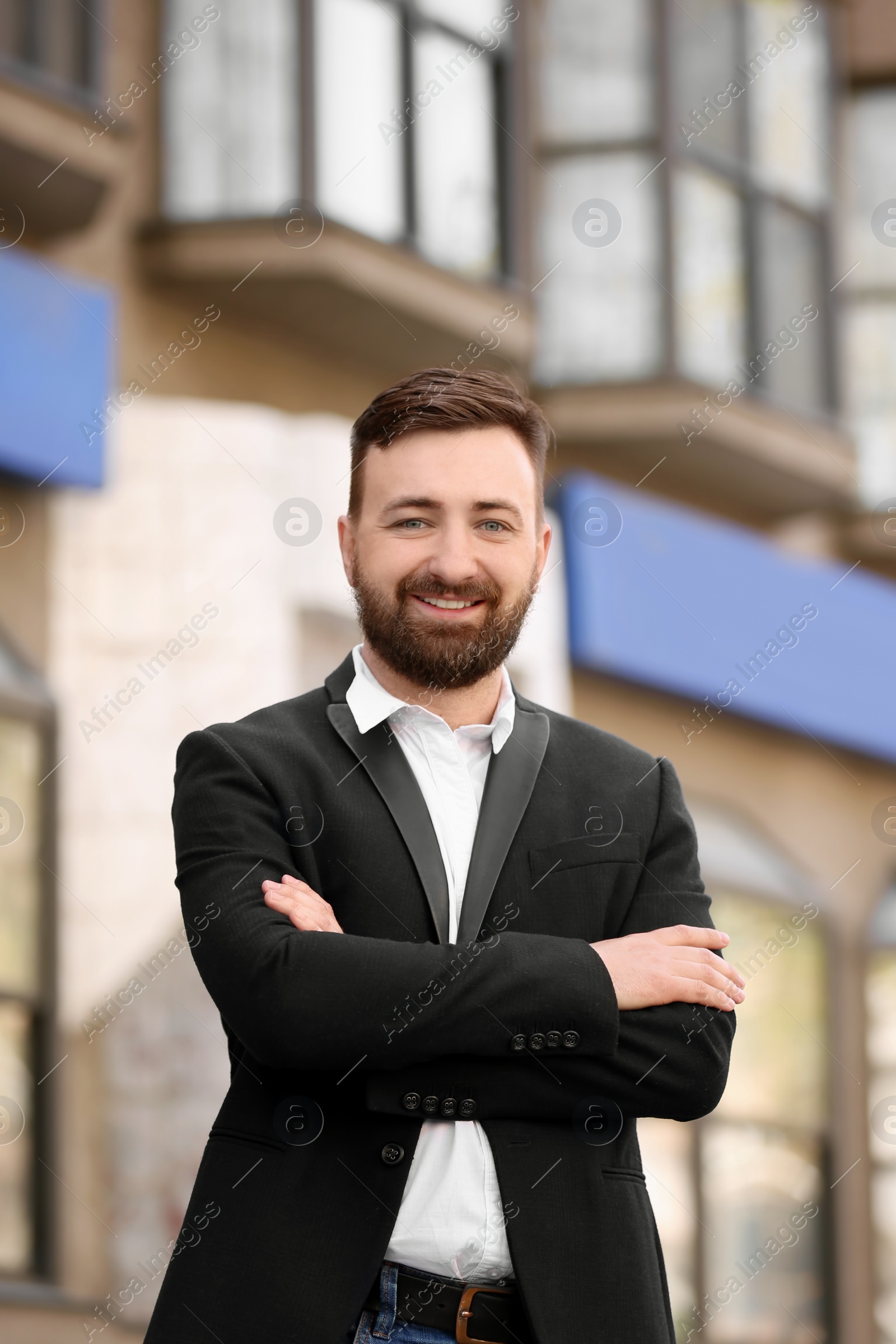 Photo of Portrait of young businessman in stylish outfit outdoors