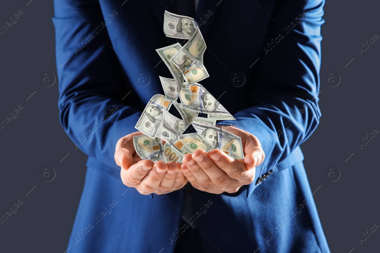 Image of Businessman with money on dark background, closeup. Currency exchange
