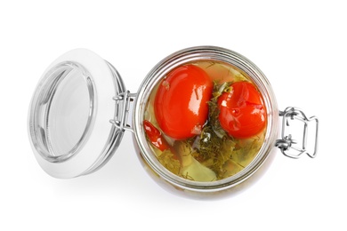 Pickled tomatoes in glass jar on white background, top view