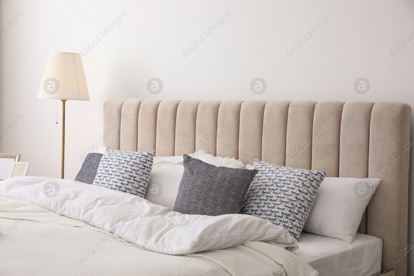 Photo of Comfortable bed with pillows in room. Stylish interior design