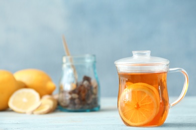 Cup of tea with lemon on table. Space for text