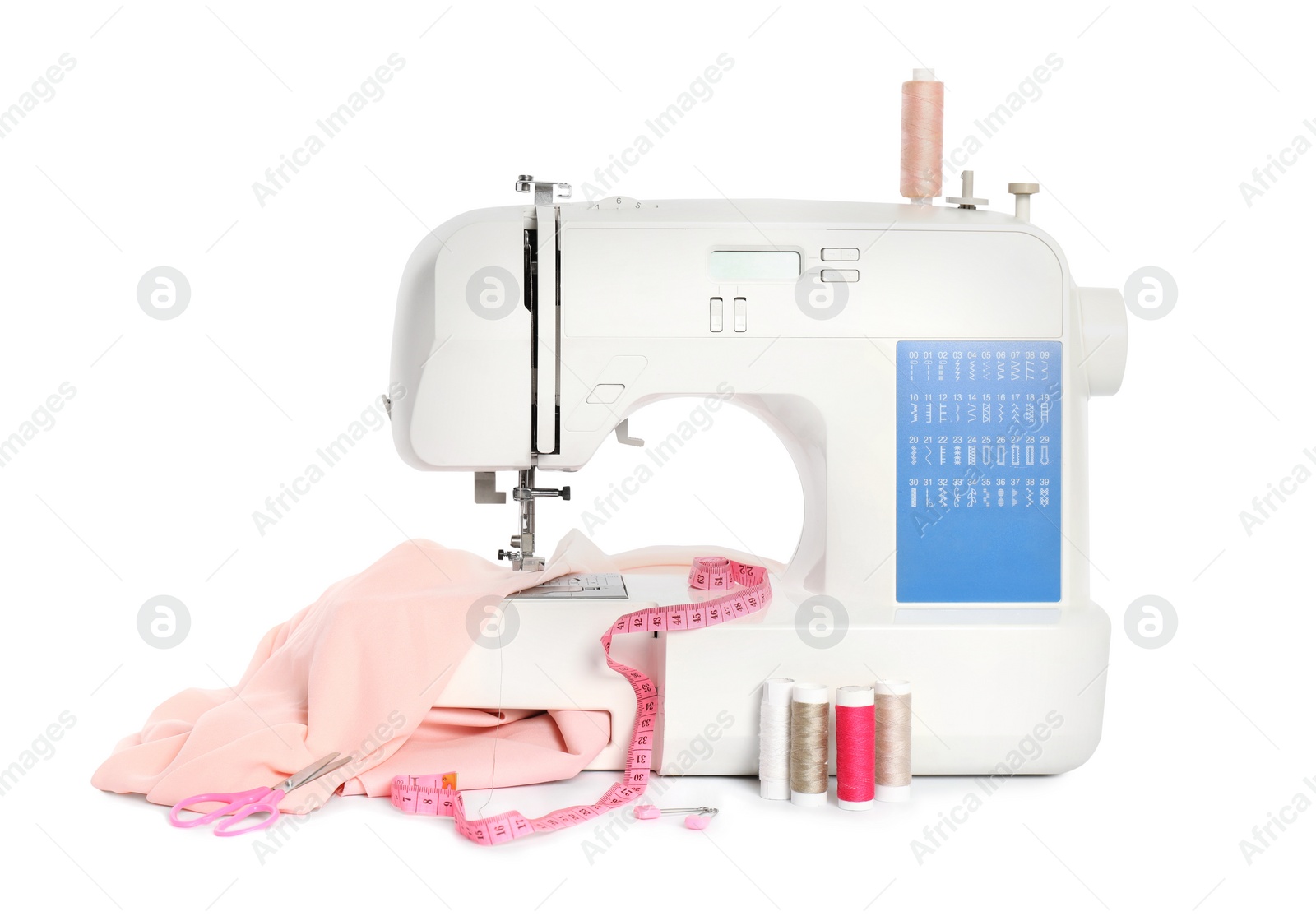 Photo of Modern sewing machine with pink cloth and craft accessories isolated on white