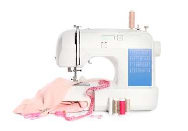 Photo of Modern sewing machine with pink cloth and craft accessories isolated on white